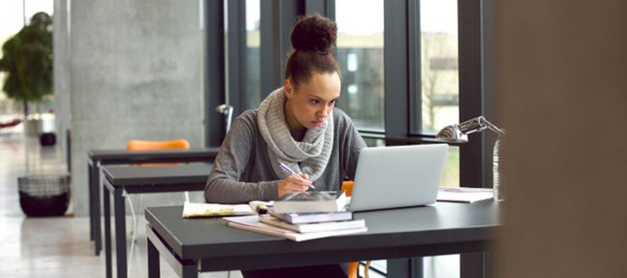 Woman working at desk with laptop